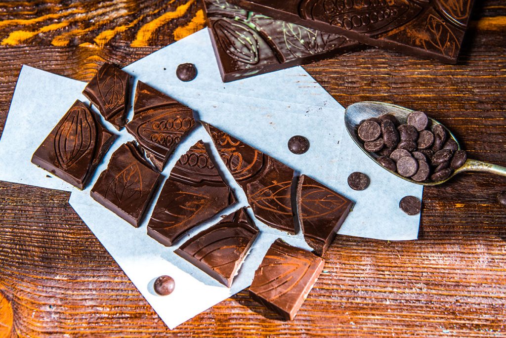 Broken chocolate on a wooden surface